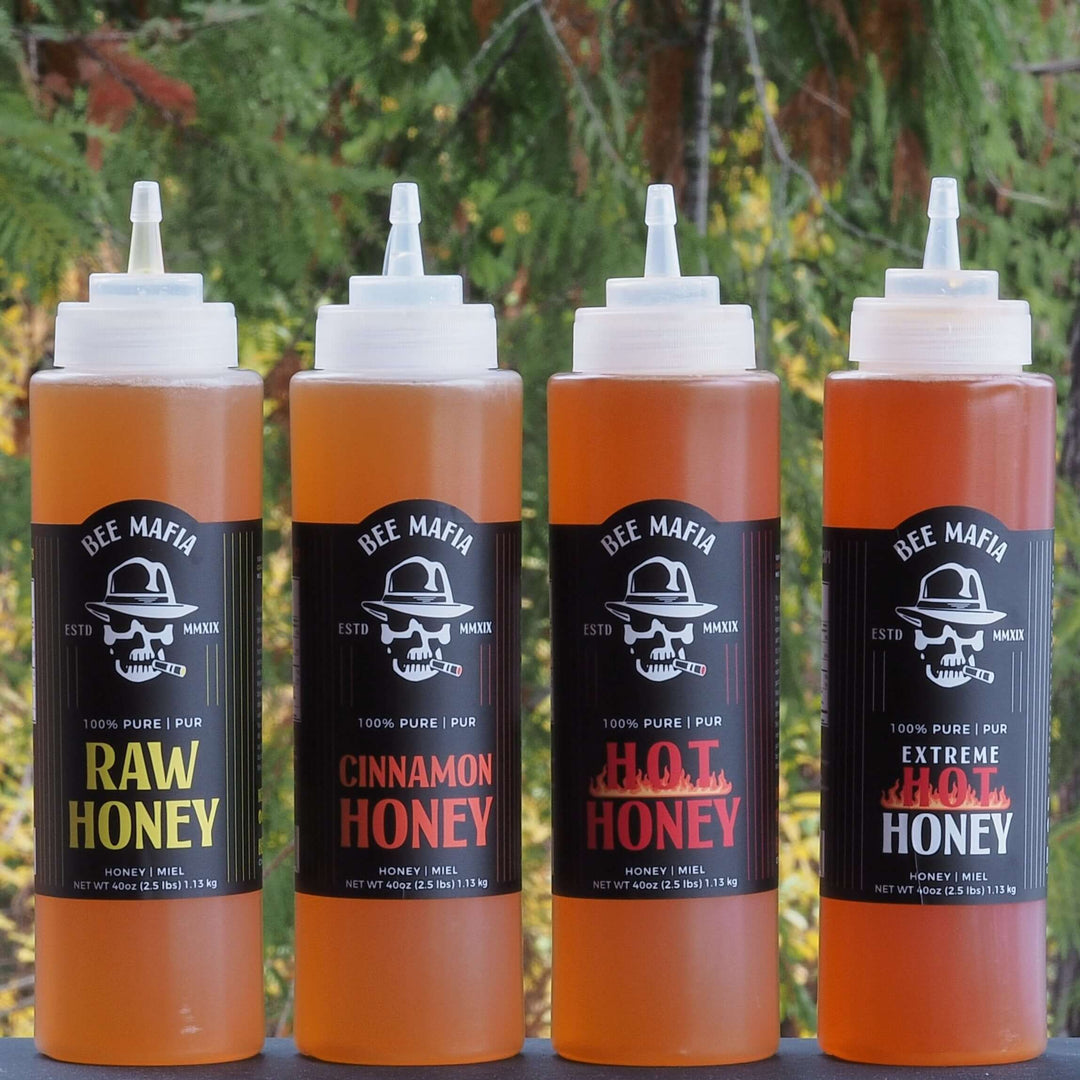 Photo of four flavored honey bottles from Bee Mafia Honey Canada. Chef bottles of 40 fl oz of honey!