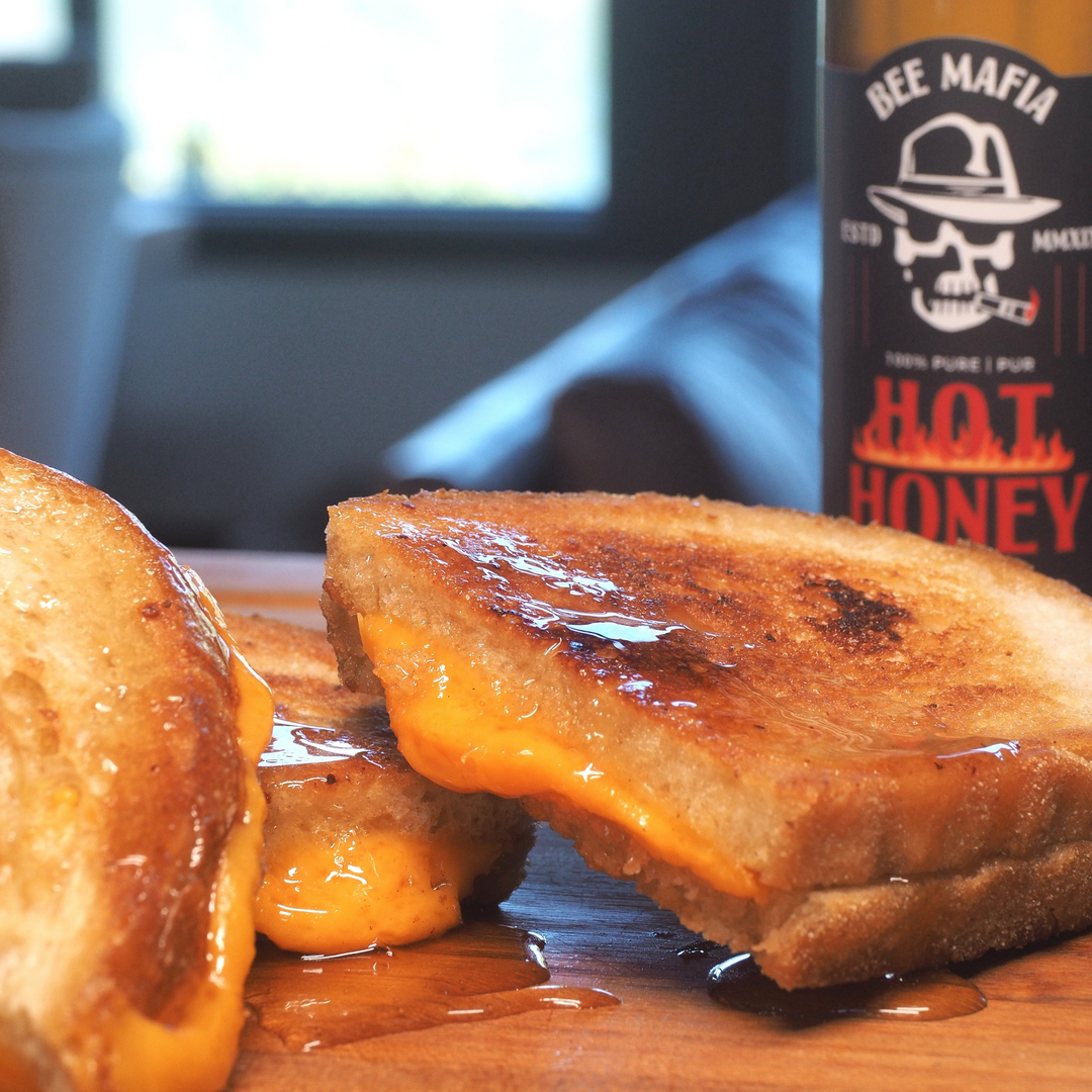 Bee Mafia Hot Honey drizzled on a grilled cheese sandwhich