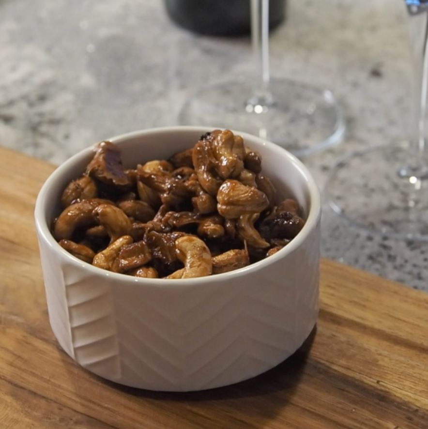 A white bowl filled with Bee Mafia Honey Roasted cashews