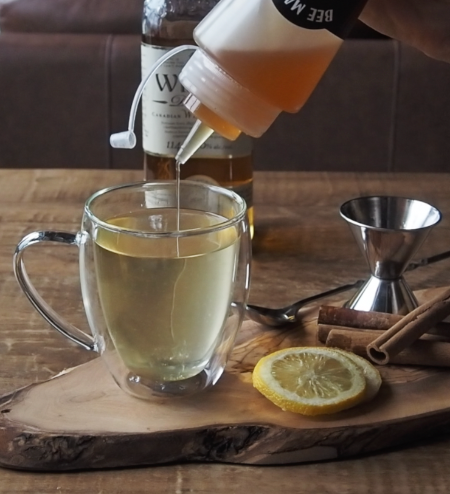 Bee Mafia Honey Canada being squeezed into Hot toddy recipe