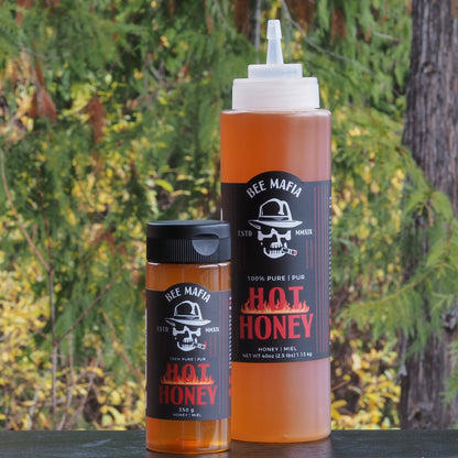 Combination pack of Bee Mafia Hot Honey products. Larger and smaller bottle with trees in the background. Product of Canada.