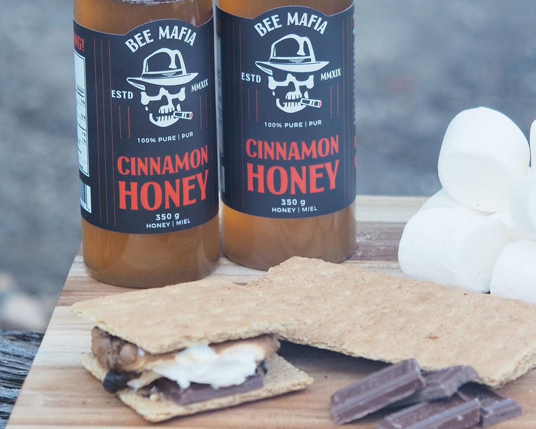 Bee Mafia Cinnamon Honey Bottles ready to be drizzled onto smore.